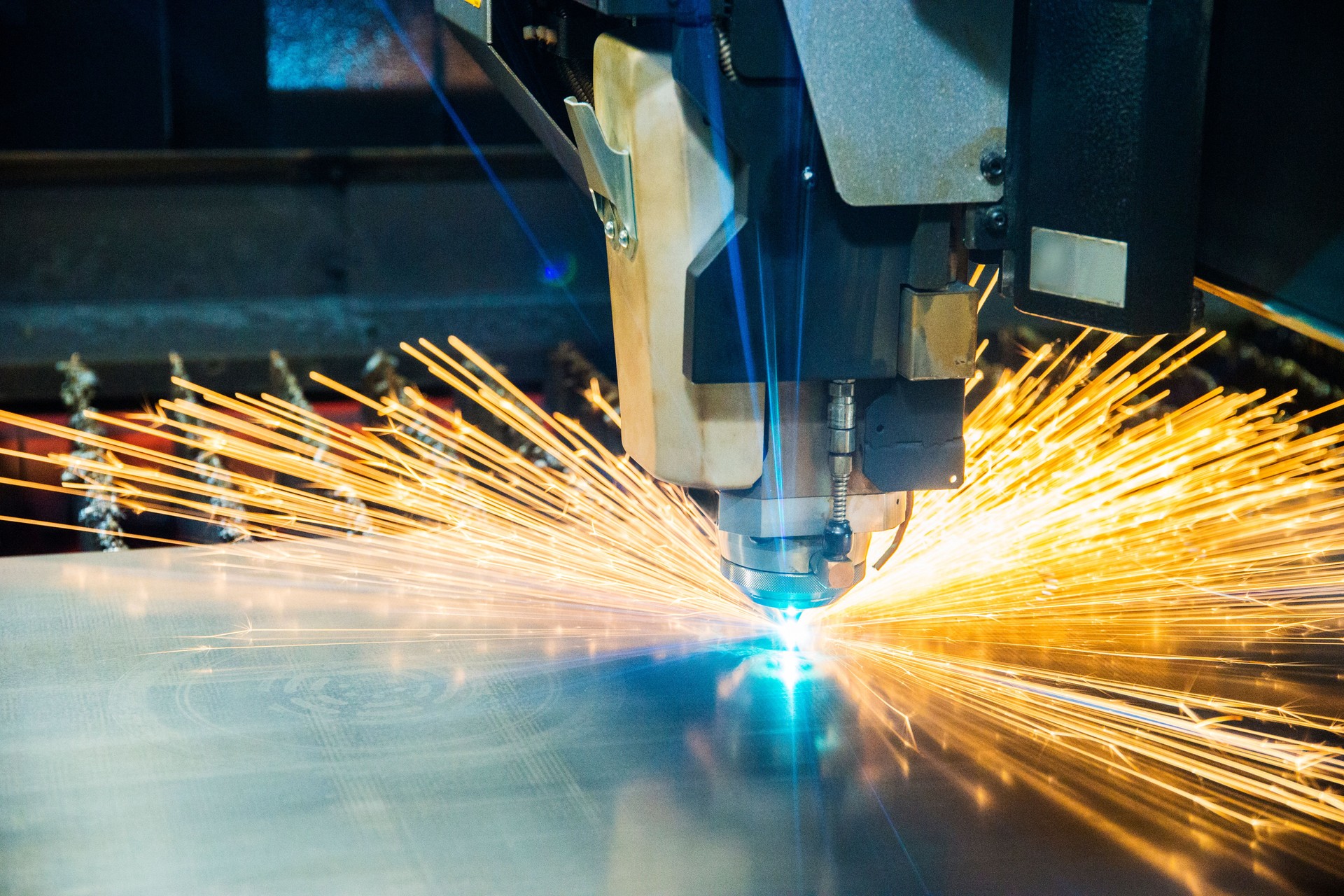 Metal laser-cutting tool cutting sheet metal.